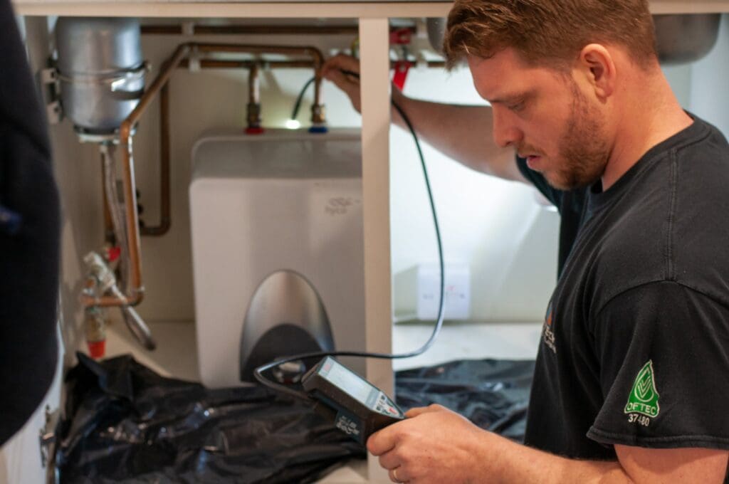 Boiler engineer checking equipment with device in hand
