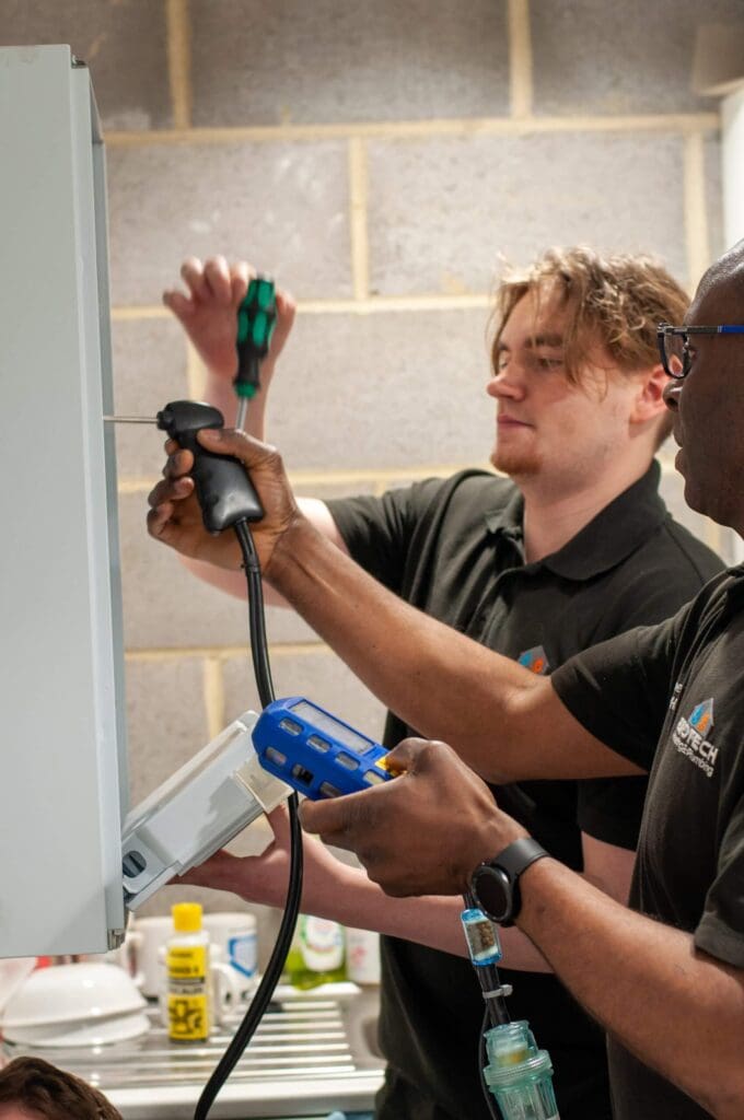 Two boiler engineers working on a boiler